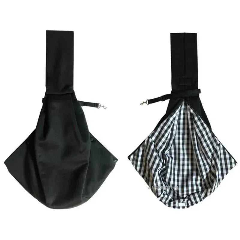 Black sling carrier showing solid exterior and plaid reversible interior lining