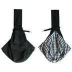 Black sling carrier showing solid exterior and plaid reversible interior lining