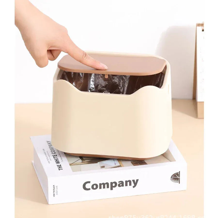 Hand pressing snap-shut lid closed on beige cat litter waste bin